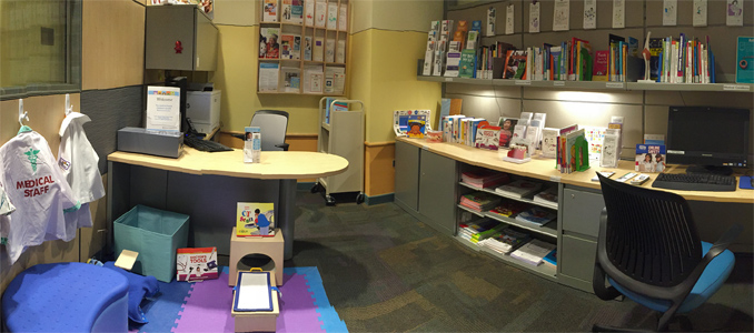 room with books, dvds, and medical play for kids