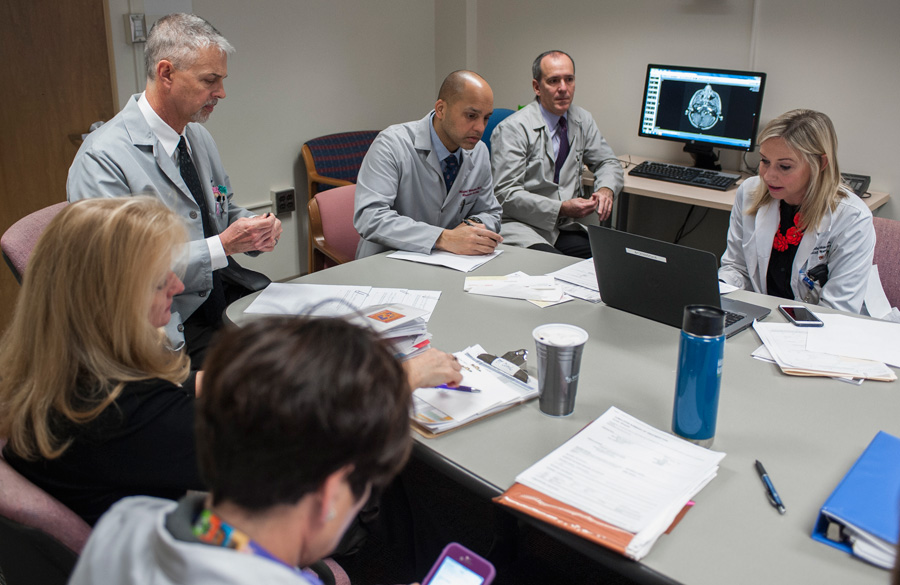 A group of Advocate Children's Hospital experts meets around a table as part of the Brain Tumor Center's MultiDisciplinary Clinic.